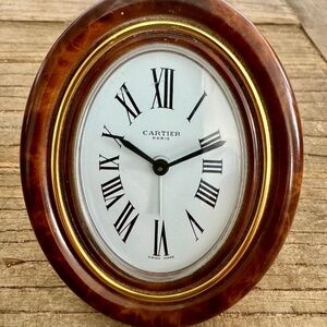 "Cartier, Travel Clock" and "Travel Frame".